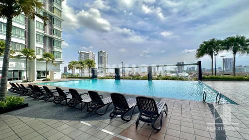 a row of chairs sitting next to a swimming pool at 9am-5pm, SAME DAY CHECK IN AND CHECK OUT, Work From Home, Shaftsbury-Cyberjaya, Comfy Home by Flexihome-MY in Cyberjaya