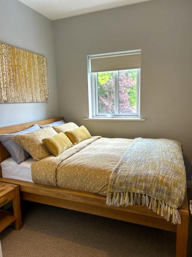 a bedroom with a large bed with a window at NEM House in Galway