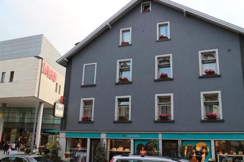 a gray building with flower boxes in the windows at Hotel Pension Graf in Konstanz