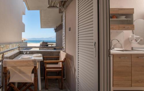 a kitchen with a table and a view of the ocean at house giota in Sarti