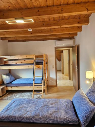a room with two bunk beds and a couch at Gästehaus Rana in Rust
