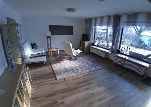 a living room with a chair and a window at Hibiskus - a83456 in Leutkirch im Allgäu