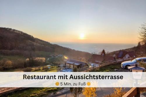 a sign that reads restart nutrient mile austleness with a sunset in the background at Black Forest Stay - Apartment Hirschperle in Sasbachwalden