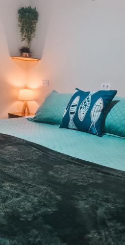 a bedroom with a bed with a pillow and a lamp at Flat Noronha Dreams in Fernando de Noronha