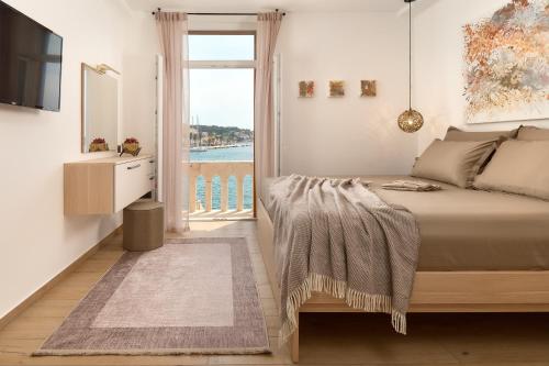 a bedroom with a bed with a view of the water at Apartment Mama Marija in Hvar