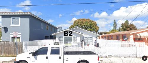 a white truck parked in front of a white house at B2 Best Value on Private Bedroom with Private Bathroom in Little Havana, Miami in Miami