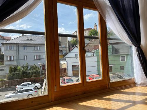 a large window with a view of a city at Apartmán s výhledem na zámek I in Vimperk