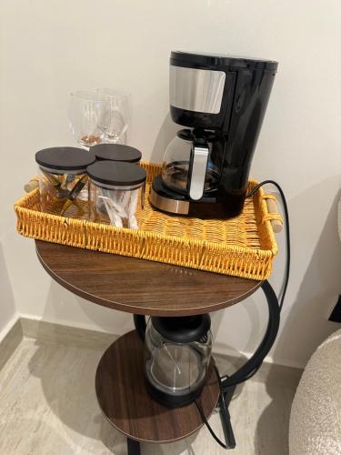 a coffee maker and glasses on a table at استديو مودرن العقيق in Riyadh