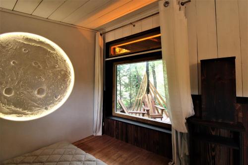 a room with a window with a view of a tent at Habitat Créateur - Hébergements insolites au camping municipal "Les Ecureuils" in Recoubeau