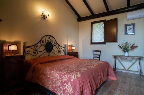 a bedroom with a bed with a red bedspread at Borgata Baldazza in Linguaglossa