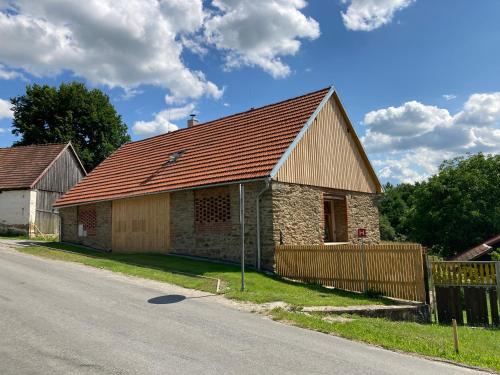an old stone building on the side of a road at Stodola 63 in Pacov