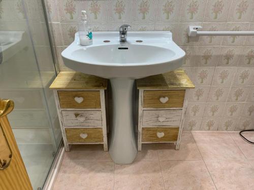 a bathroom with a white sink in a room at Broadway es Mar in El Perelló