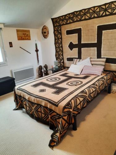 a bedroom with a large bed with a wooden headboard at Villa La Faute-sur-Mer in La Faute-sur-Mer