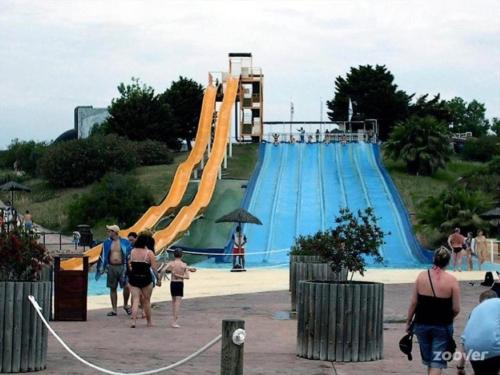 people walking around a water slide at a water park at Atico A in Salou