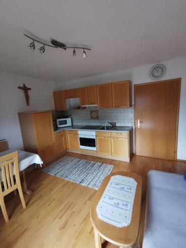 a small kitchen with wooden cabinets and a table at Haus Schrei in Grundlsee