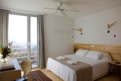 a bedroom with a bed and a large window at Narköy Ecologic Hotel & Organic Farm in Kocaeli