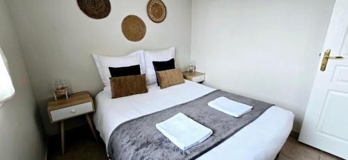 a bedroom with a large white bed with two pillows at L'Eden in Thonon-les-Bains