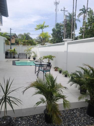 a patio with a table and chairs and plants at Gated Riverside Studio Apartment in San Juan