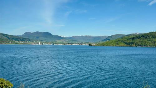 a large body of water with mountains in the background at Magnar in Etnesjøen