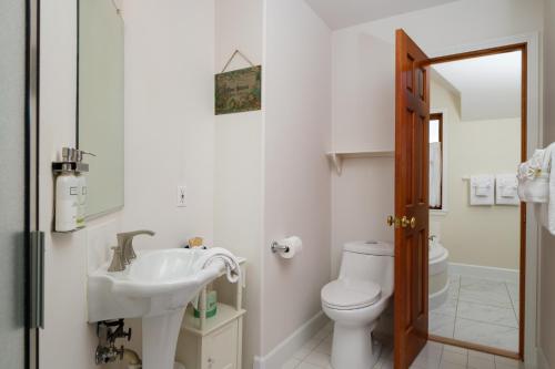a bathroom with a sink and a toilet at Arch Cape Inn and Retreat in Arch Cape