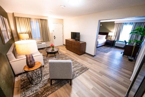 a living room with a couch and a television at Mai Hana Hotel- Intl Drive, Trademark Collection by Wyndham in Orlando