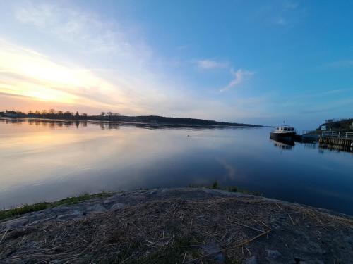 a boat is docked on a lake at sunset at Mickiewiczówka in Nickelswalde
