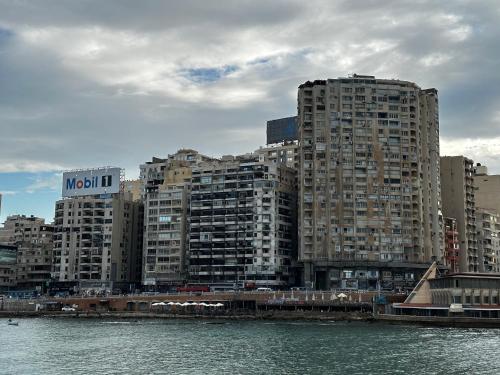 a group of tall buildings next to a body of water at Nabeel Homes - Seaview Building - 3 Units in Gleem in Alexandria