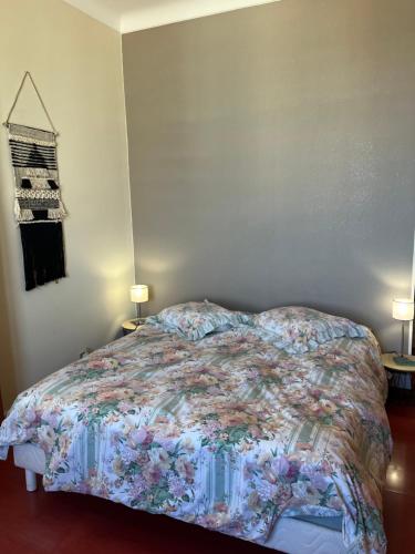a bedroom with a bed with a colorful comforter at Plein coeur de Monaco, à 300 mètres à pied du port de Monaco, 4 pièces dans des escaliers vue mer exceptionnelle in Monte Carlo