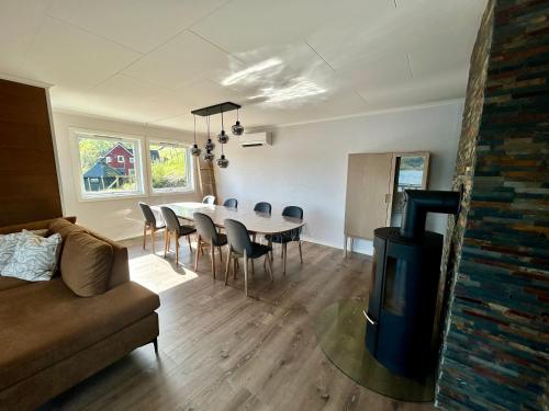 a living room with a table and chairs and a couch at Magnar in Etnesjøen