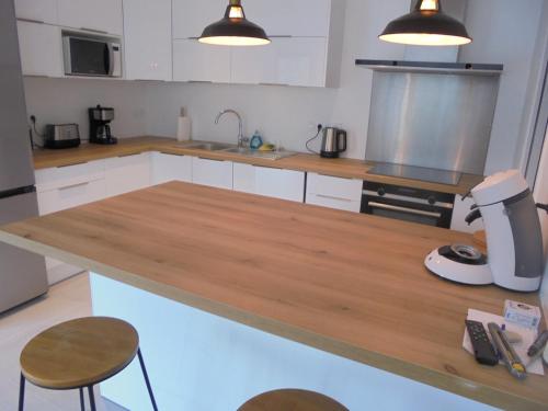 a kitchen with a wooden counter top with a mixer at Maison de tourisme Conleau in Vannes