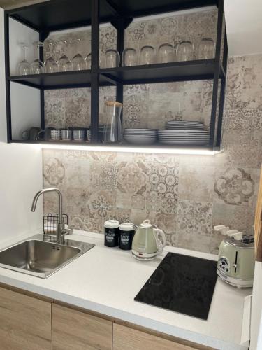 a kitchen with a sink and a counter top at Dimora Santa Teresa in Monopoli