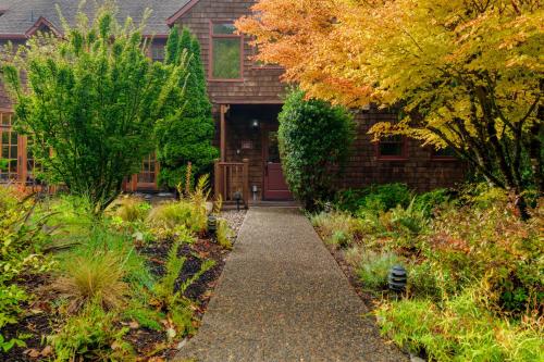 a walkway in front of a house with trees at Arch Cape Inn and Retreat in Arch Cape