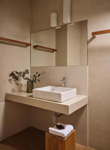 a bathroom with a white sink and a mirror at Cielo villas - An Authentic Mediterranean Living in Zakynthos Town