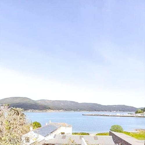 a view of a large body of water with houses at Vicedo White Sand in O Vicedo