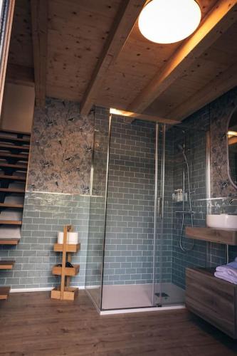 a bathroom with a glass shower and a sink at Apartamento Villa Carlota in Cudillero