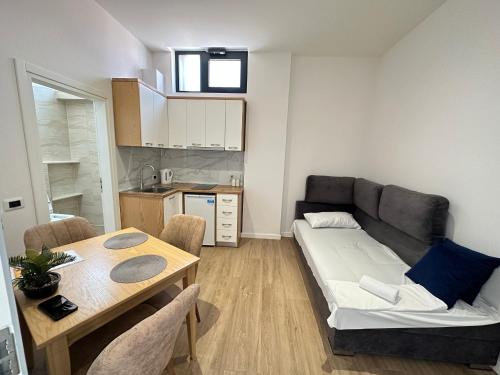 a living room with a couch and a table at Arial Trinity Suites in Vlorë