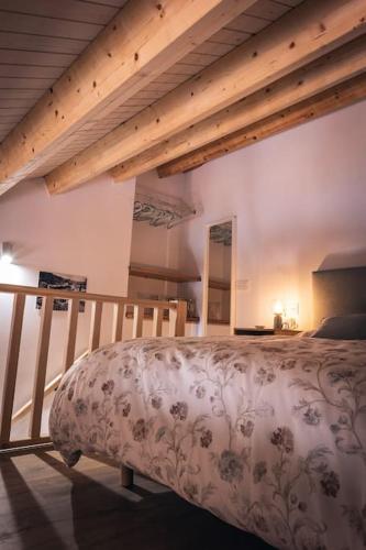 a bedroom with a bed in a room with wooden beams at Apartamento Villa Carlota in Cudillero