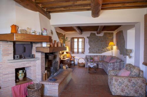 Villa Rachele في Larciano: غرفة معيشة مع أريكة ومدفأة
