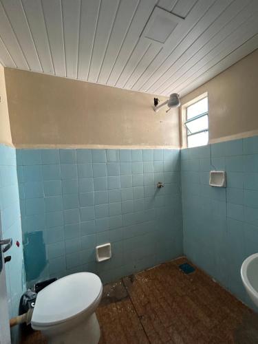 a bathroom with a toilet and a sink at Hotel Centro in Corumbá