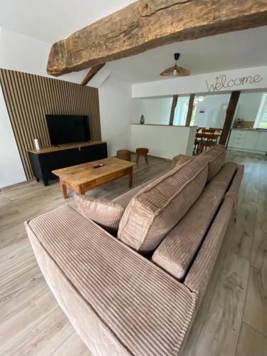 a living room with a couch and a table at Le gîte du bonheur in Dalou