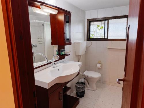 a bathroom with a sink and a toilet at Apartment with patio and parking in Nahariyya
