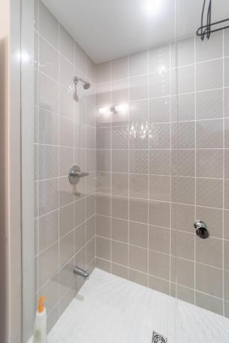 a bathroom with a shower with a glass door at Beautiful New Townhouse in Quiet Neighbourhood in Ajax