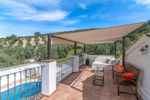 a patio with a table and a pool at Valle de Oro in Villanueva de Algaidas
