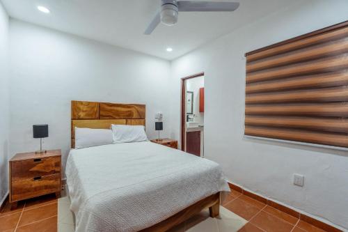a white bedroom with a bed and a window at New Puerto Vallarta Retreat with Private Terrace in Puerto Vallarta