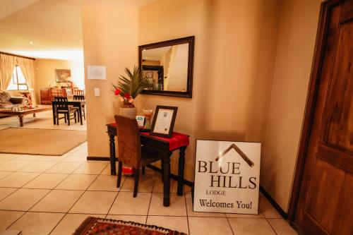 a blue hills house welcomes you sign in a living room at Blue Hills Lodge in Midrand