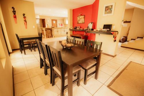 a dining room and kitchen with a table and chairs at Blue Hills Lodge in Midrand