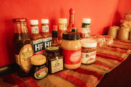 a table topped with lots of different types of condiments at Blue Hills Lodge in Midrand