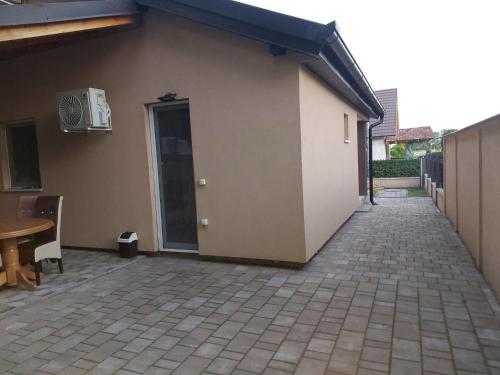 a building with a door and a patio at Vikendica Nika in Palić
