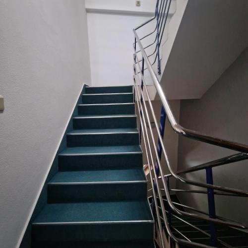 a staircase with blue steps in a building at Bydlím U Arény in Nová Ves