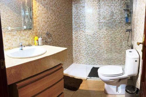 a bathroom with a sink and a toilet and a shower at Apartamento Casa el Canario in Costa Teguise